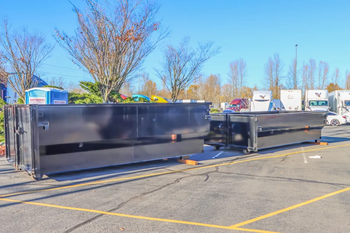 Professional dumpster rental service with roll-off container on residential driveway in Grand Island